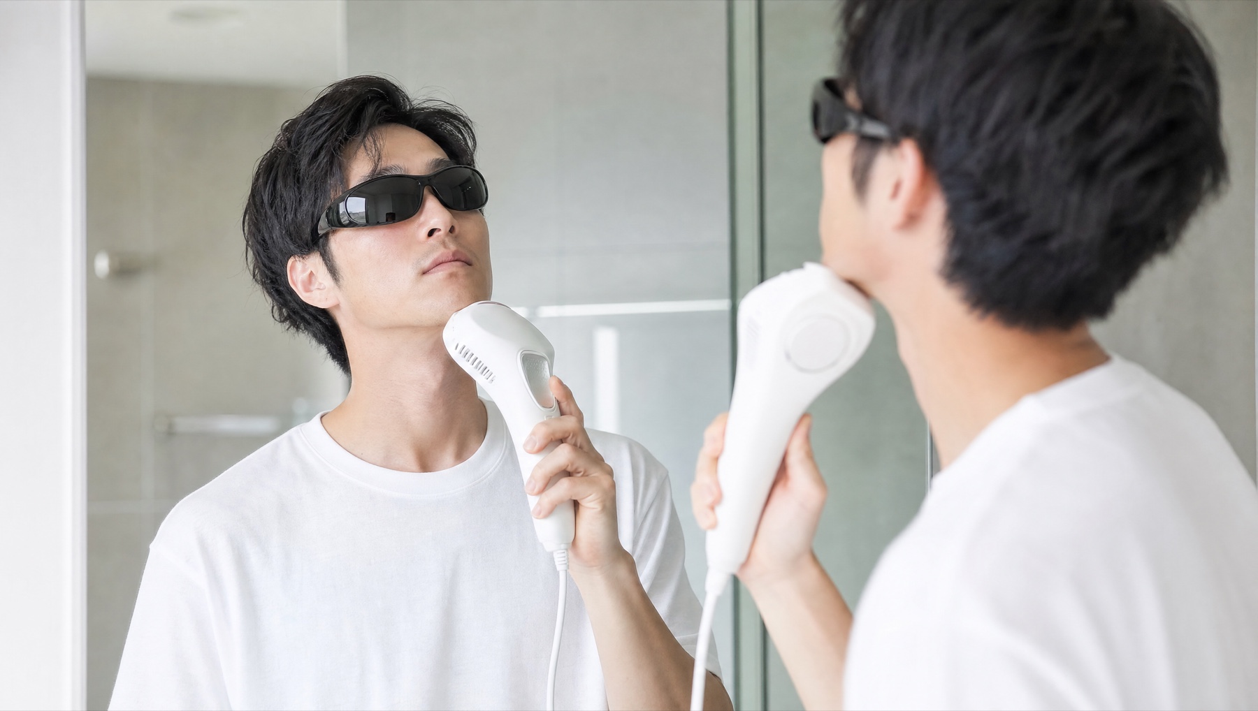 自宅で家庭用脱毛器を使う男性