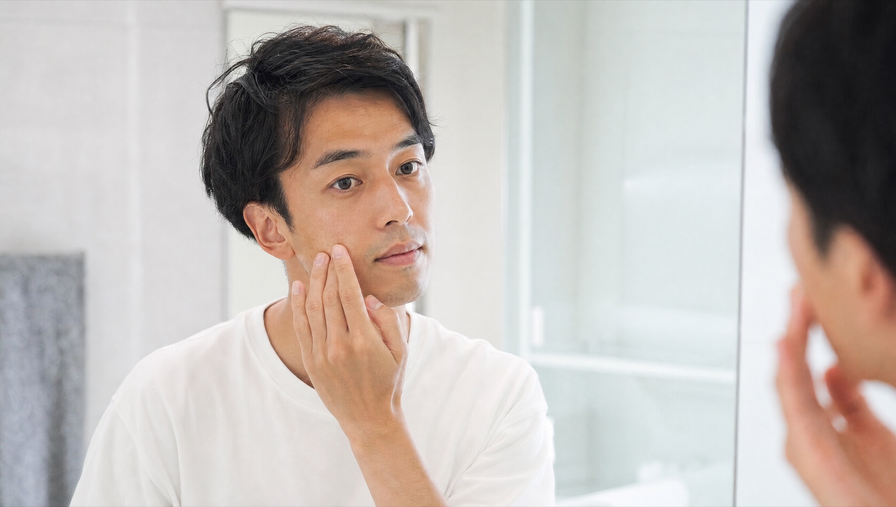 洗顔後に保湿ケアをする男性